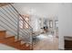 Open living space with hardwood floors, dining area, and staircase at 2034 Newton St, Denver, CO 80211