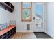 Inviting mudroom with a storage bench, cubbies, coat hooks, and a convenient dog door at 2034 Newton St, Denver, CO 80211