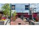 Edgewater Beer Garden boasts community seating in a beautiful outdoor area with string lights and shade trees at 2034 Newton St, Denver, CO 80211