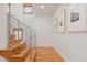 Modern staircase with wood steps and metal railings, leading to a bright hallway at 2034 Newton St, Denver, CO 80211