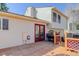 Home's backyard deck features wood flooring and a red-framed sliding glass door at 15099 E Wagontrail Pl, Aurora, CO 80015