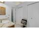 Bathroom featuring a single sink vanity with large mirror and two closets at 15099 E Wagontrail Pl, Aurora, CO 80015