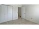 Neutral bedroom featuring a closet, carpeting, and doorway leading to another room at 15099 E Wagontrail Pl, Aurora, CO 80015