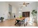 Bright dining room featuring vaulted ceilings, light hardwood floors, adjacent to an open floorplan at 15099 E Wagontrail Pl, Aurora, CO 80015
