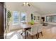 Bright dining room featuring vaulted ceilings, light hardwood floors, and a clear view to the living room at 15099 E Wagontrail Pl, Aurora, CO 80015