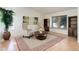 Bright living room featuring vaulted ceilings, light hardwood floors, and a neutral color palette with area rug at 15099 E Wagontrail Pl, Aurora, CO 80015