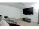 Finished basement has an entertainment area including couch and mounted television at 15099 E Wagontrail Pl, Aurora, CO 80015