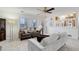 Spacious living room with a ceiling fan, and views of the kitchen and large windows at 15099 E Wagontrail Pl, Aurora, CO 80015