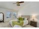 Inviting main bedroom with vaulted ceiling, two windows, neutral carpet, and cozy decor at 15099 E Wagontrail Pl, Aurora, CO 80015