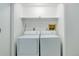 Functional laundry area features washer and dryer, and a shelf for storage solutions at 15099 E Wagontrail Pl, Aurora, CO 80015
