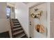 Interior view of the entrance featuring carpeted stairs and door with decorations at 10211 Ura Ln # 10-105, Thornton, CO 80260