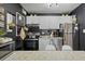 Cozy and tidy kitchen with stainless steel appliances and black back splash at 10211 Ura Ln # 10-105, Thornton, CO 80260