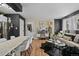 Stylish living room featuring dark accent walls, wood flooring, and eclectic decor at 10211 Ura Ln # 10-105, Thornton, CO 80260