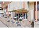 Outdoor patio seating area with stone and a view of windows at 10211 Ura Ln # 10-105, Thornton, CO 80260