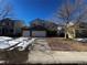 Two-story home with attached two-car garage and a partially snow-covered front yard at 11383 Oakland Dr, Commerce City, CO 80640