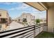 Balcony with black railings overlooks a street of attractive homes in this residential neighborhood at 11132 Via Lata Dr, Broomfield, CO 80020