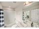 Bathroom features a shower-tub combo and a vanity with a large mirror over the sink at 11132 Via Lata Dr, Broomfield, CO 80020
