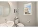 Cozy powder room featuring a pedestal sink, modern fixtures, and bright natural light at 11132 Via Lata Dr, Broomfield, CO 80020