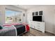 A bedroom with a large window offers a view of the neighborhood, as well as motivational signage at 11132 Via Lata Dr, Broomfield, CO 80020