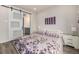 A bedroom features a sliding door to an ensuite bathroom and is decorated with soothing colors and artwork at 11132 Via Lata Dr, Broomfield, CO 80020