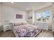 Serene bedroom boasts a large window, hardwood floors, and neutral decor for a peaceful retreat at 11132 Via Lata Dr, Broomfield, CO 80020