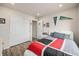 This bedroom features red and gray bedding, sports-themed decor, and closet for easy storage at 11132 Via Lata Dr, Broomfield, CO 80020