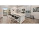 Modern kitchen featuring a spacious island with barstool seating, stainless appliances, and stylish cabinets at 11132 Via Lata Dr, Broomfield, CO 80020