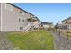 Spacious backyard with lawn, stairs to a back deck, and a partially gravel landscape at 1420 E Witherspoon Dr, Elizabeth, CO 80107