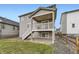 Backyard features a walkout deck, a small yard, and a fence separating neighboring properties at 1420 E Witherspoon Dr, Elizabeth, CO 80107