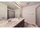Well-lit bathroom with a double sink vanity and a shower/tub combo at 1420 E Witherspoon Dr, Elizabeth, CO 80107