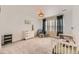 Bright Bedroom featuring a crib, rocking chair, and charming decor at 1420 E Witherspoon Dr, Elizabeth, CO 80107