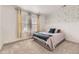 Cozy bedroom featuring a comfortable bed, stylish wallpaper, and natural light at 1420 E Witherspoon Dr, Elizabeth, CO 80107