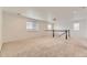 Upstairs bonus room features neutral carpeting, a staircase, and lots of natural light at 1420 E Witherspoon Dr, Elizabeth, CO 80107
