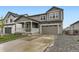 Charming two-story home with stone accents, a two-car garage, and well-maintained landscaping at 1420 E Witherspoon Dr, Elizabeth, CO 80107