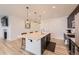 Contemporary kitchen featuring a central island with pendant lights, open to the living area at 1420 E Witherspoon Dr, Elizabeth, CO 80107