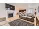Open-concept living room with fireplace and modern kitchen in the background at 1420 E Witherspoon Dr, Elizabeth, CO 80107
