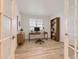 Bright home office with natural light, modern desk, and wood-style floors at 1420 E Witherspoon Dr, Elizabeth, CO 80107