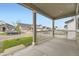 Relaxing covered front porch view showcasing neighborhood homes and green lawns at 1420 E Witherspoon Dr, Elizabeth, CO 80107