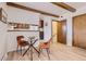 Charming dining area with glass-top table and modern seating at 13627 W Alaska Dr, Lakewood, CO 80228