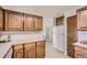 Oak kitchen cabinets and white appliances at 13627 W Alaska Dr, Lakewood, CO 80228