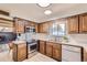 Bright kitchen featuring wood cabinets, stainless steel appliances, and light flooring at 13627 W Alaska Dr, Lakewood, CO 80228