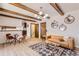 Living room boasts wood beam accents and a comfy, neutral sofa at 13627 W Alaska Dr, Lakewood, CO 80228