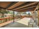 Covered patio with wooden deck and partial view of backyard at 13627 W Alaska Dr, Lakewood, CO 80228