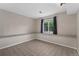 Finished basement area with tile flooring, a large window, and neutral walls at 11532 Newland St, Westminster, CO 80020