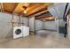 Unfinished basement with laundry area featuring modern washer and dryer at 11532 Newland St, Westminster, CO 80020