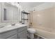Bathroom with shower and tub combination, modern vanity with sink, and decorative mirror at 11532 Newland St, Westminster, CO 80020