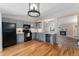 Charming kitchen with blue cabinets, updated appliances, and hardwood flooring at 11532 Newland St, Westminster, CO 80020