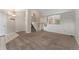 Open living room boasting plush carpeting, a staircase, and a view into the dining area at 11532 Newland St, Westminster, CO 80020