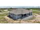Aerial back view of house with covered patio and large yard, on a sunny day at 1180 Antelope W Dr, Bennett, CO 80102