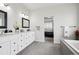Bright bathroom featuring dual sink vanity, framed mirrors, and views of the main bedroom and soaking tub at 1180 Antelope W Dr, Bennett, CO 80102